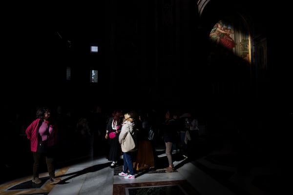 Tourists visit St. Peter's Basilica at the Vatican, Friday, Feb. 28, 2025. (AP Photo/Bernat Armangue)