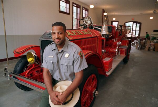 Marty Smith has a long history with the National Park Service. Here, he poses on the fender of a restored fire engine inside Atlanta Fire Department Station No. 6 at the corner of Auburn Avenue and Boulevard on June 25, 1996. The station was restored as a fire department museum in the historic district. AJC FILE PHOTO / DAVID TULIS