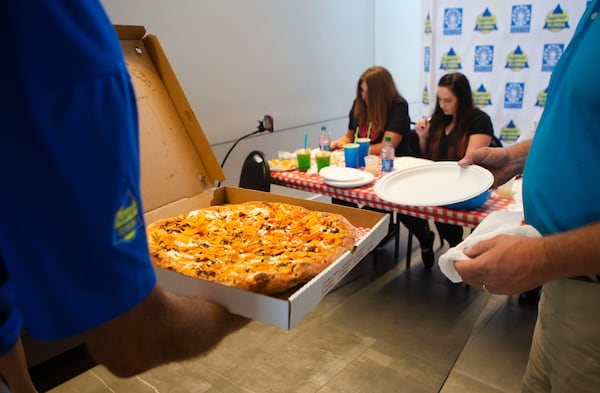 A Doritos pizza by Gillette's Pizza and Lemonade is carried to the judge's table during the Crazy Food Contest at the North Georgia State Fair at Jim R. Miller Park in Marietta, Georgia. Gillette's Pizza won the best taste category for their Doritos pizza. Sonny Fowler, a franchisee of Scoville Hot Chicken, won the most creative category for his chicken and waffle taco. CHRISTINA MATACOTTA FOR THE ATLANTA JOURNAL-CONSTITUTION. 