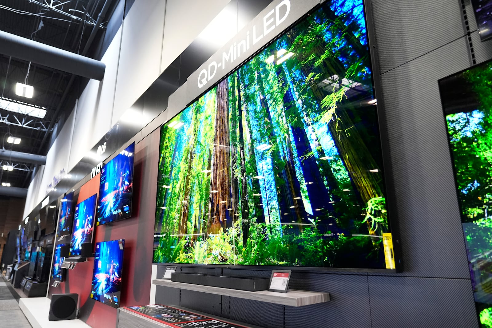 A 115-inch TCL television, right, is displayed at a Best Buy store in Dallas, Friday, Oct. 25, 2024. (AP Photo/Tony Gutierrez)