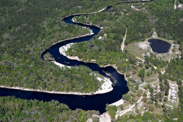 An aerial photograph shows the St. Mary River dividing border of Georgia and Florida on March 19. The Georgia Environmental Protection Division (EPD) released draft permits to Twin Pines Minerals for a 584-acre mine that would extract titanium and other minerals from atop the ancient sand dunes on the swamp’s eastern border, which holds water in the refuge. (Hyosub Shin/AJC)