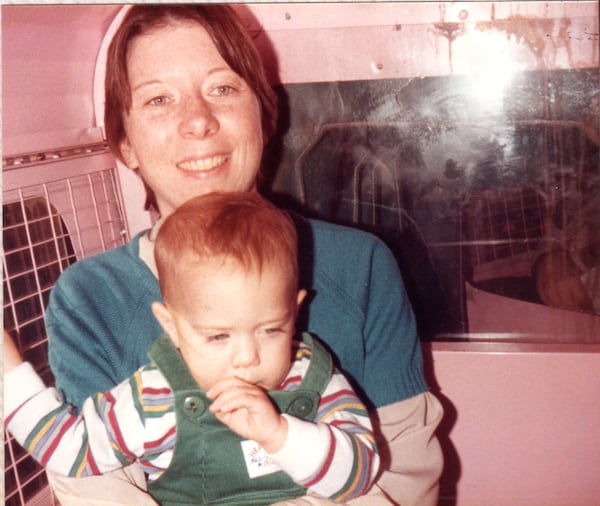 The Pink Pig has been part of the Christmas traditions at Mary Ann Howard's family for four generations. In this photo from 1984, Howard takes a ride on the Pink Pig with her son Andrew. (Courtesy of Mary Ann Howard)