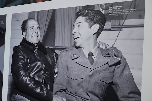 An image of Korea war Medal of Honor recipient Sgt. First Class Joseph Rodriguez, right, interacting with his father, Joseph, left, is on display at the National Medal of Honor Museum in Arlington, Texas, Thursday, March 13, 2025. (AP Photo/Tony Gutierrez)