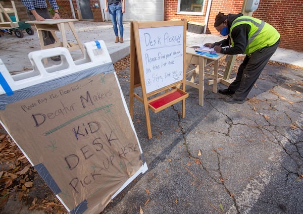 Mario McKee signs in to receive his desk at the Decatur Makers on Friday, November 11, 2020.  STEVE SCHAEFER FOR THE ATLANTA JOURNAL-CONSTITUTION  