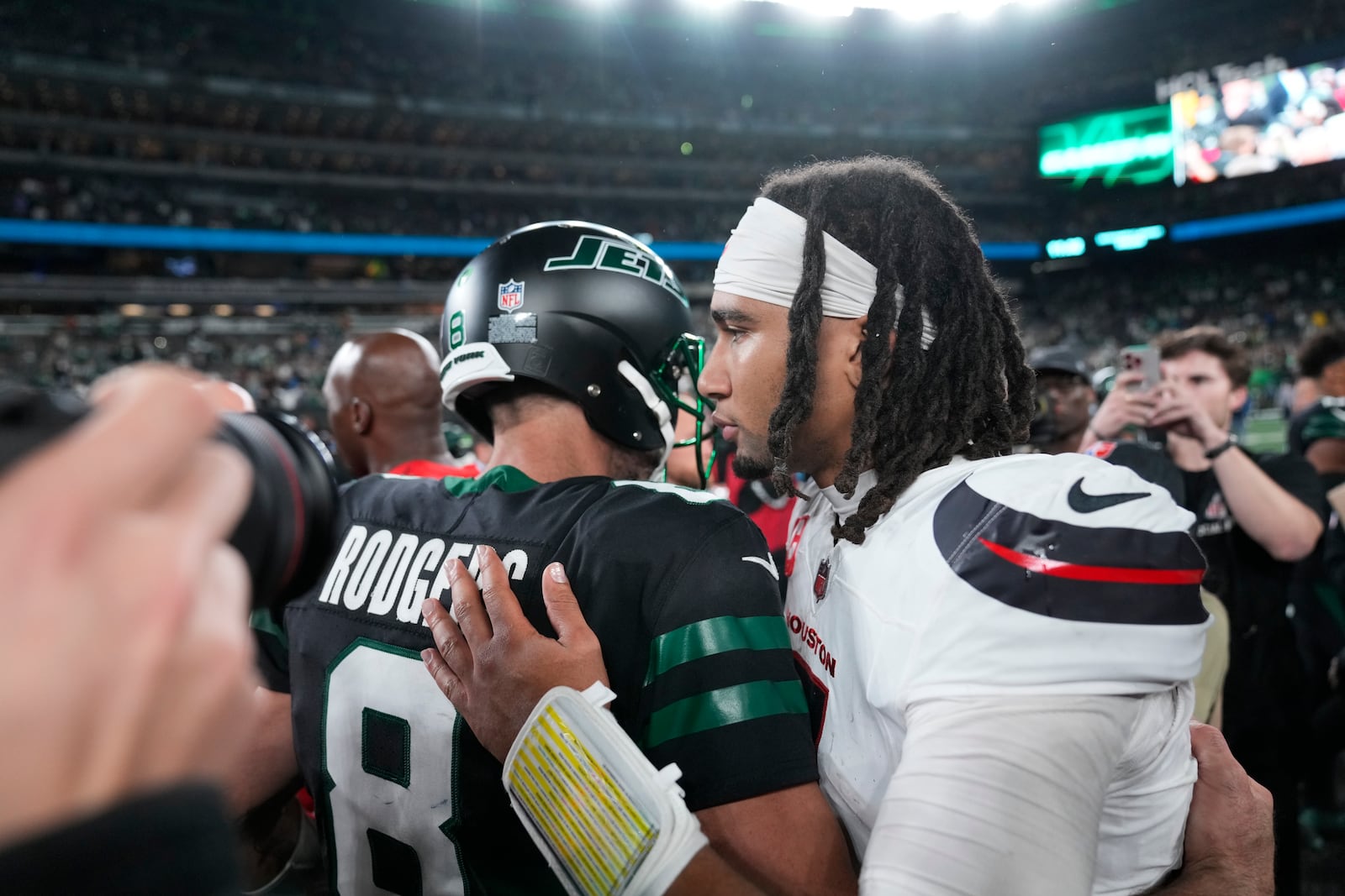 New York Jets quarterback Aaron Rodgers (8) hugs Houston Texans quarterback C.J. Stroud after an NFL football game Thursday, Oct. 31, 2024, in East Rutherford, N.J. (AP Photo/Seth Wenig)