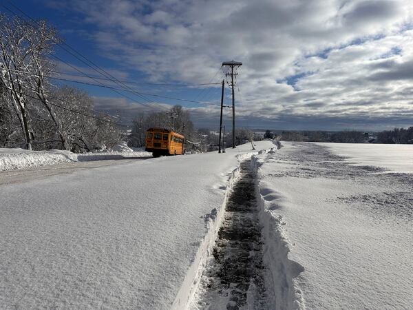 A school bus is on a delayed schedule after a snow storm in Lowville, N.Y., Monday, Dec. 2, 2024. (AP Photo/Cara Anna)