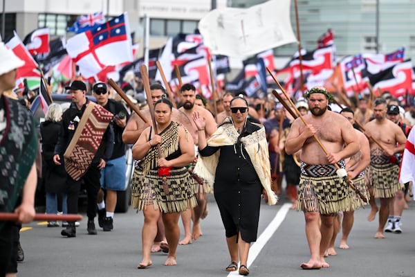 Indigenous Māori people walk through the streets of Wellington, New Zealand to protest against a proposed law that would redefine the country's founding agreement between Indigenous Māori and the British Crown, Tuesday, Nov. 19, 2024. (AP Photo/Mark Tantrum)