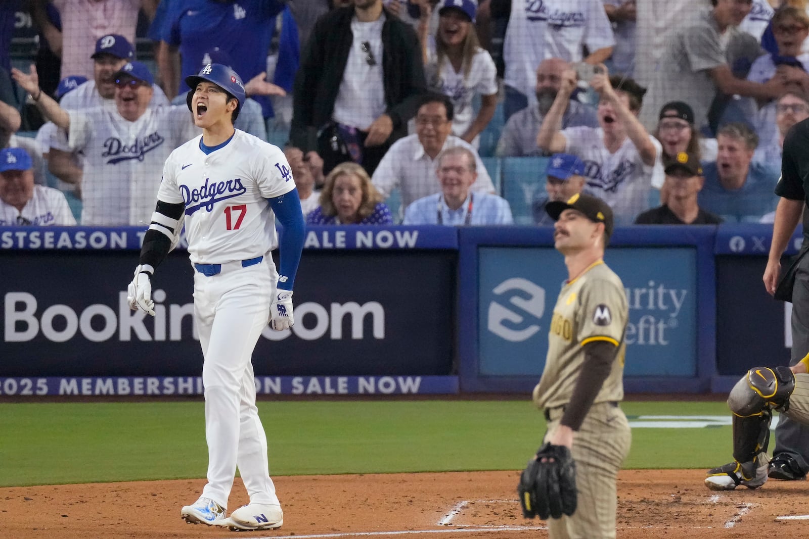 Los Angeles Dodgers' Shohei Ohtani (17) reacts after hitting a three-run home run off San Diego Padres pitcher Dylan Cease, foreground, during the second inning in Game 1 of baseball's NL Division Series, Saturday, Oct. 5, 2024, in Los Angeles. (AP Photo/Mark J. Terrill)