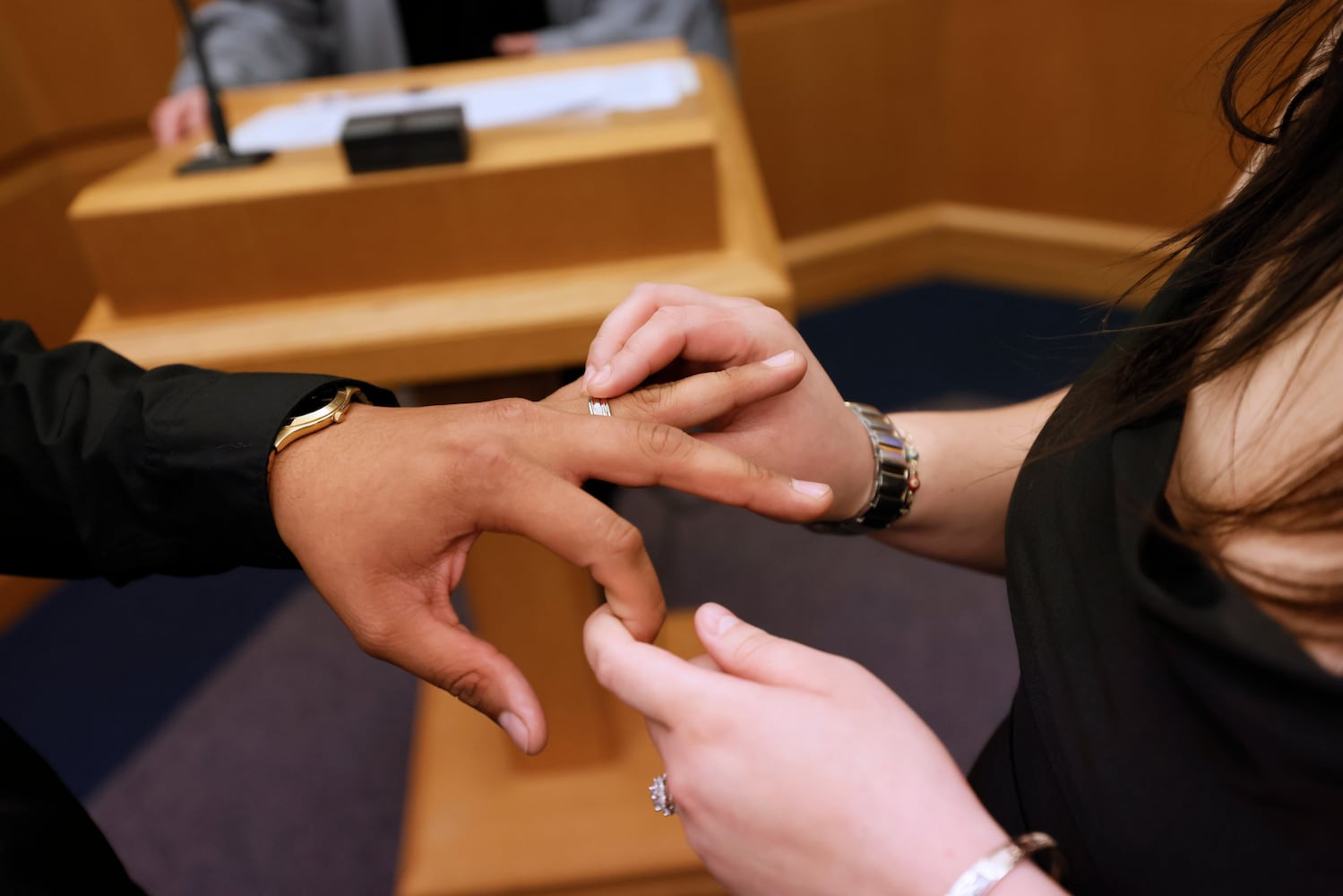 Alma Escobar puts the wedding ring to Jonathan López during their wedding in Courtroom 1C of the Gwinnett County Courthouse in Lawrenceville on Valentine’s Day, Tuesday, February 14, 2023. Miguel Martinez / miguel.martinezjimenez@ajc.com