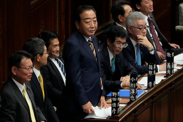 Yoshihiko Noda, center, head of the Constitutional Democratic Party of Japan, attends a special parliamentary session of the lower house for parliamentary voting for a new leader, Monday, Nov. 11, 2024, in Tokyo. (AP Photo/Eugene Hoshiko)