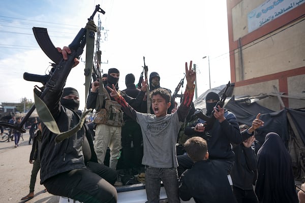 Members of the Izzedine al-Qassam Brigades, the armed wing of the Palestinian group Hamas, take part in a parade as they celebrate a ceasefire agreement between Hamas and Israel in Deir al-Balah, Gaza Strip, Sunday, Jan. 19, 2025. (AP Photo/Abdel Kareem Hana)