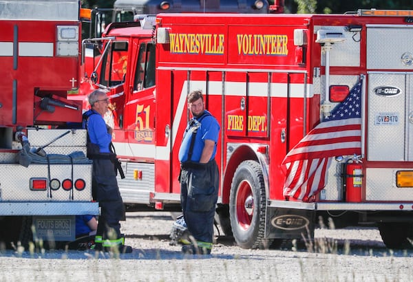 Firefighters from Brantley County find some shade from a fire truck as they wait in a holding area near the Symrise chemical plant on Colonel's Island. Multiple agencies were called in to assist after an explosion and early morning fire at the Symrise chemical plant in Brunswick Georgia on Monday November 7, 2022.