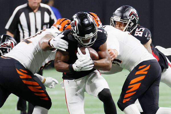 Falcons running back Bijan Robinson (7) brakes the defense as he runs the ball during the first half in a preseason exhibition game against the Cincinnati Bengals at Mercedes-Benz Stadium on Friday, August 18, 2023, in Atlanta. 
Miguel Martinez/miguel.martinezjimenez@ajc.com