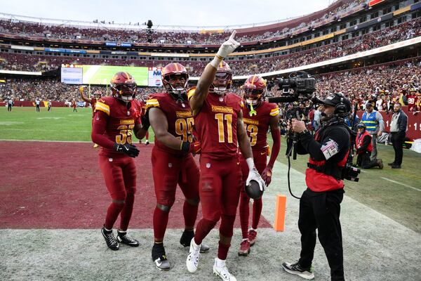 Washington Commanders safety Jeremy Chinn (11) points to the crowd after intercepting a pass intended for Pittsburgh Steelers wide receiver George Pickens during the second half of an NFL football game, Sunday, Nov. 10, 2024, in Landover, Md. (AP Photo/Nick Wass)