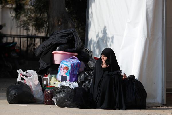 A girl waits at the border between Lebanon and Syria as Lebanese families return to Lebanon through the Jousieh border crossing, Syria, Thursday, Nov. 28, 2024, following a ceasefire between Israel and Hezbollah that went into effect on Wednesday. (AP Photo/Omar Sanadiki)