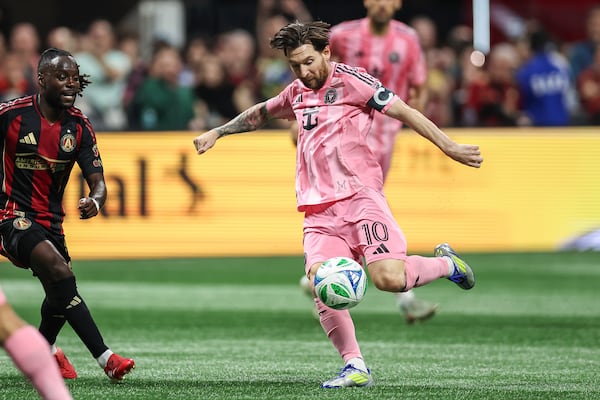 Inter Miami forward Lionel Messi (10) attempts a shot against Atlanta United midfielder Tristan Muyumba, left, during the first half of an MLS soccer match, Sunday, March 16, 2025, in Atlanta. (AP Photo/Colin Hubbard)