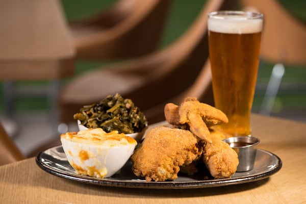 The Molly B’s Fried Chicken, a half Springer Mountain chicken, is shown with white cheddar mac and cheese and braised collard greens, along with a SweetWater 420. CONTRIBUTED BY MIA YAKEL