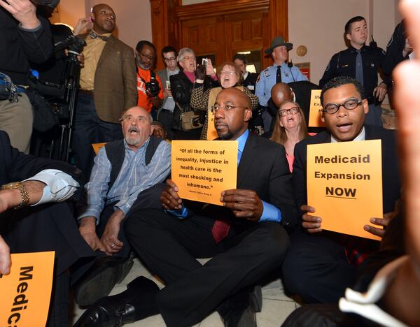 Democratic U.S. Sen. Raphael Warnock has a history of activism on the subject of Medicaid. In 2014, before he was elected to the Senate, he was arrested following a sit-in at the Georgia Capitol protesting the state’s refusal to take advantage of federal funds to expand the safety-net insurance program that covers poor children and some elderly and disabled adults. KENT D. JOHNSON / KDJOHNSON@AJC.COM