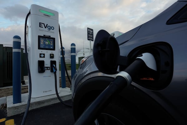 FILE - An electric vehicle charges at an EVgo fast charging station in Detroit, Nov. 16, 2022. (AP Photo/Paul Sancya, File)