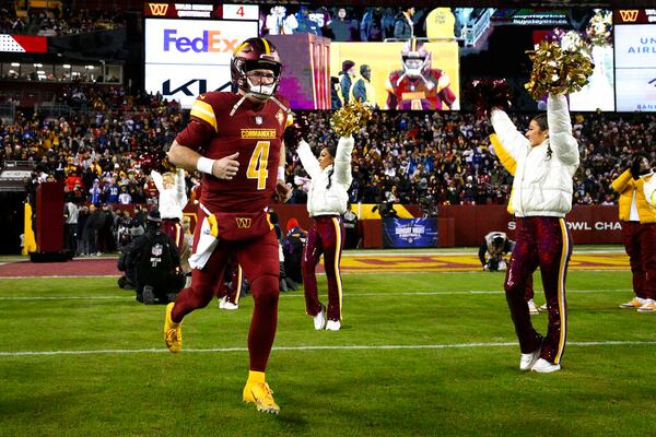 Washington Commanders quarterback Taylor Heinicke (4) takes to the field before an NFL football game against the New York Giants, Sunday, Dec. 18, 2022, in Landover, Md. (AP Photo/Nick Wass)