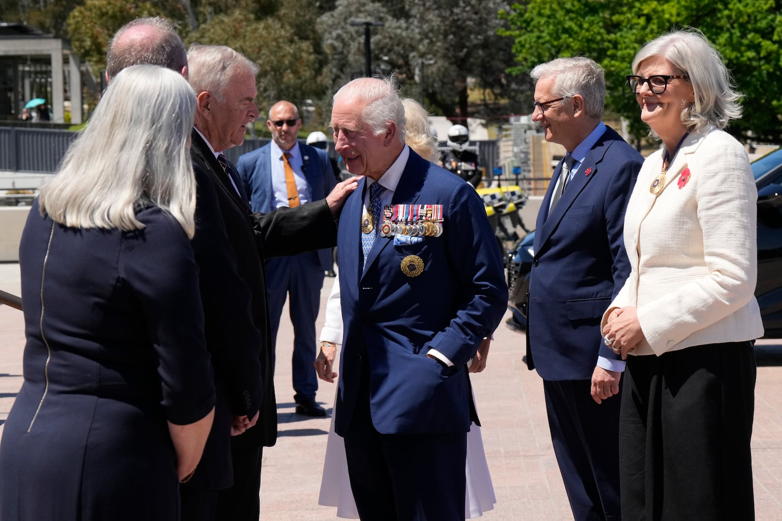 Kim Beazley, third left, chair of Australian War Memorial Council, meets Britain's King Charles III, center, on the king's arrival with Queen Camilla, partially seen at rear center, in Canberra, Australia, Monday, Oct. 21, 2024.