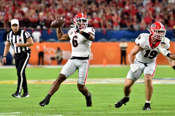 Georgia Bulldogs running back Kenny McIntosh (6) throws a 18-yard touchdown pass to wide receiver Adonai Mitchell (not pictured) during the first quarter against the Michigan Wolverines in the 2021 College Football Playoff semifinal at the Orange Bowl at Hard Rock Stadium, Friday, in Miami Gardens, Fl. (Hyosub Shin / Hyosub.Shin@ajc.com)