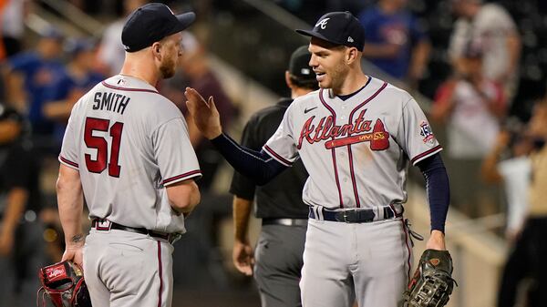 Freddie Freeman (right) congratulates reliever Will Smith (51) after Smith got out of a bases-loaded jam in the bottom of the seventh inning of the second baseball game of a doubleheader against the New York Mets, Monday, June 21, 2021, in New York.