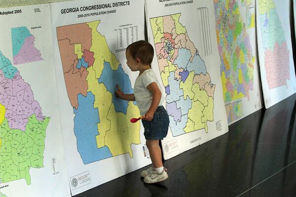 A child looks over Georgia redistricting maps during a public hearing. AJC 2011 file photo