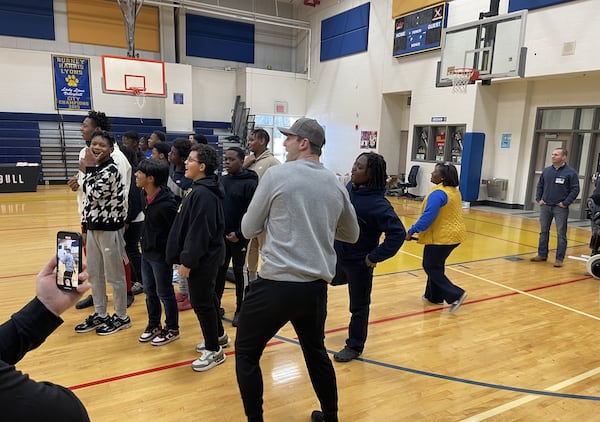 Brock Bowers prepares to throw a pass while interacting with students at Burney-Harris-Lyons Middle School in Athens Tuesday.