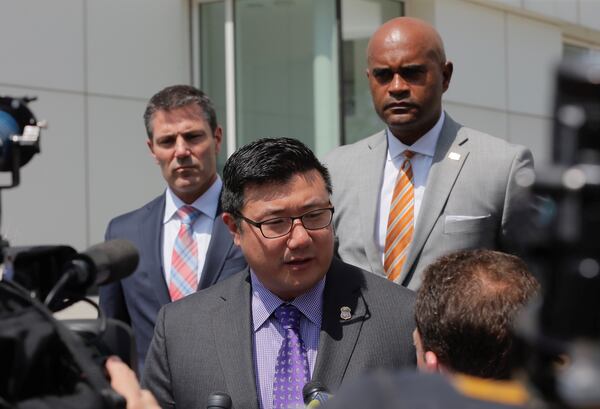 U.S. Attorney Byung J. “BJay” Pak, along with Chris Hacker (far left), FBI Special Agent in charge and Thomas Holloman III (left), IRS investigator, talk to media after Wednesday’s hearings. BOB ANDRES /BANDRES@AJC.COM