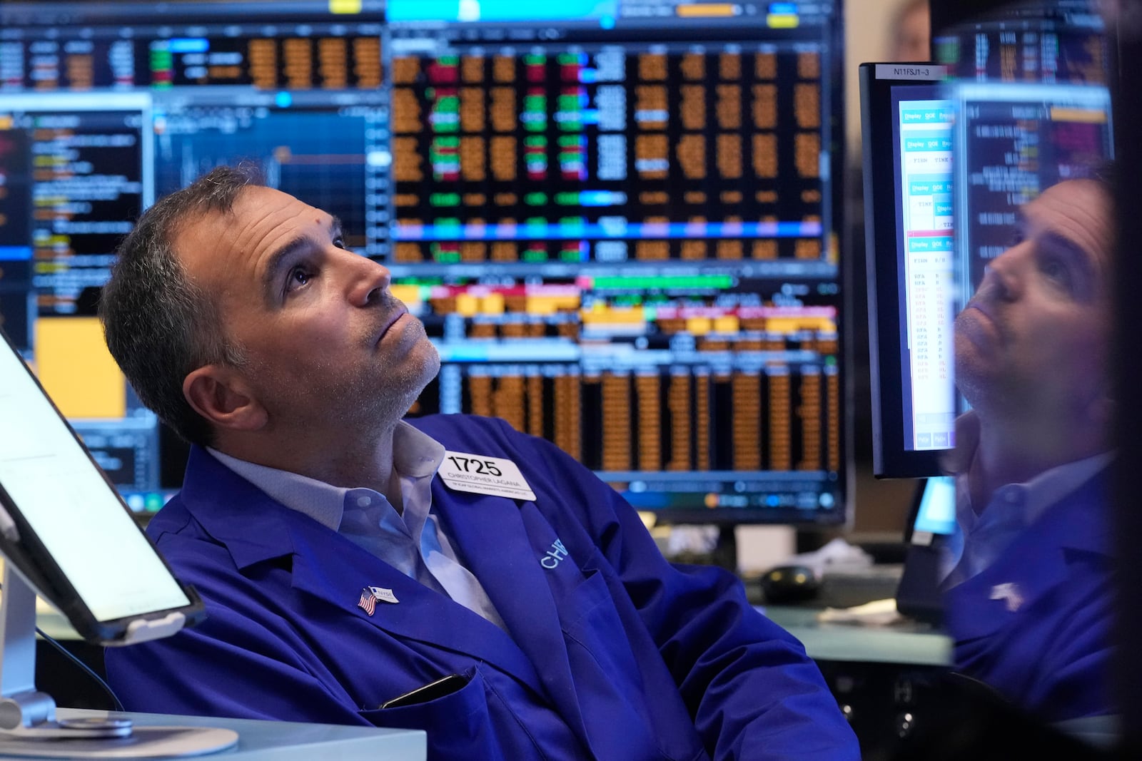 Trader Christopher Lagana is reflected in one of his monitors as he works on the floor of the New York Stock Exchange, Thursday, Nov. 7, 2024. (AP Photo/Richard Drew)