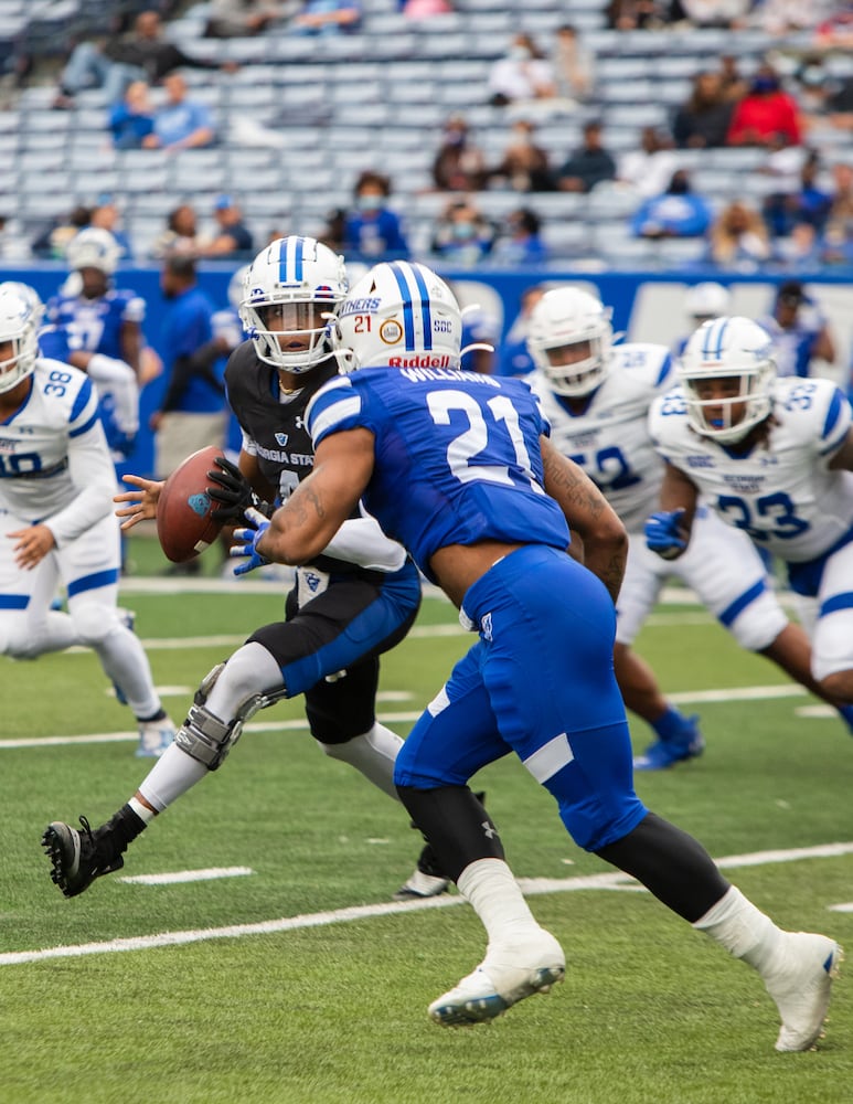 Cornelious Brown IV (4), blue team quarterback, scrambles in the pocket during the Georgia State University spring football game on Friday, April 16, 2021, at Center Parc Stadium in Atlanta. The white team defeated the blue team 23-17. CHRISTINA MATACOTTA FOR THE ATLANTA JOURNAL-CONSTITUTION