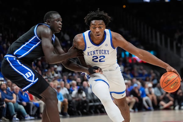 Kentucky center Amari Williams (22) drives against Duke center Khaman Maluach (9) during the first half of an NCAA college basketball game, Tuesday, Nov. 12, 2024, in Atlanta. (AP Photo/John Bazemore )