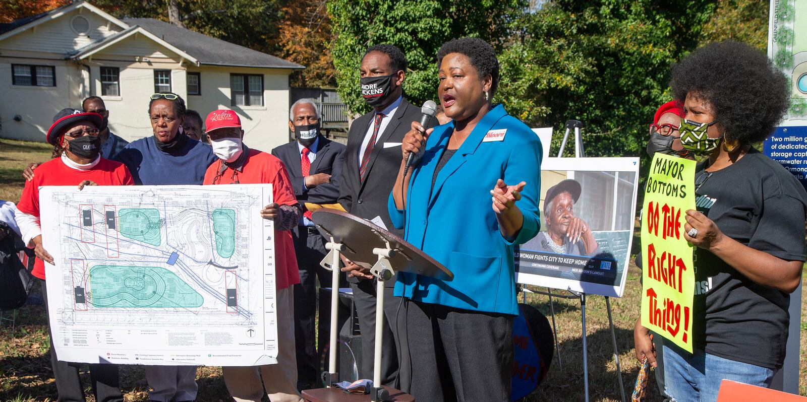 Andre Dickens (center) listens as Feilcia Moore speaks during an Anti-Election rally where Peoplestown residents are fighting the city of AtlantaÕs year long attempt to take away their homes. The city is trying to do so in order to improve the flood protection conditions in Peoplestown. PHIL SKINNER FOR THE ATANTA JOURNAL-CONSTITUTION