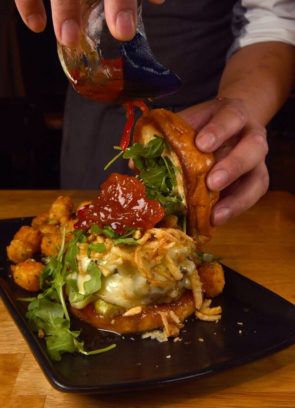 A Death by Peaches Burger is topped with Peach Pepper Jam at Stage Kitchen & Bar. (Styling by chef Vereak Chum / Chris Hunt for the AJC)