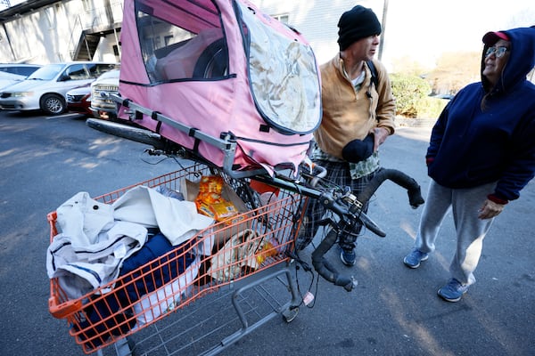 Tracy Thompson, right, director of the nonprofit Elizabeth Foundation, speaks with Mike as he is ready to go visit The Hill, a homeless encampment burned by a brush fire days earlier on Nov. 9. Mike collected items that the Elizabeth Foundation and partners provide, such as food, clothes and cleaning supplies. 
Miguel Martinez / miguel.martinezjimenez@ajc.com