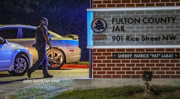 Law enforcement, national and local news outlets and Donald Trump supporters wait outside the Fulton County Jail on Thursday ahead of the former president's surrender.