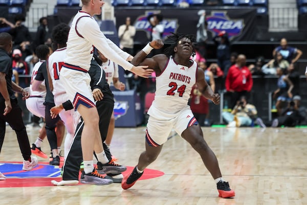 Sandy Creek High School's Amari Latimer celebrates with teammates at the Macon Centreplex.