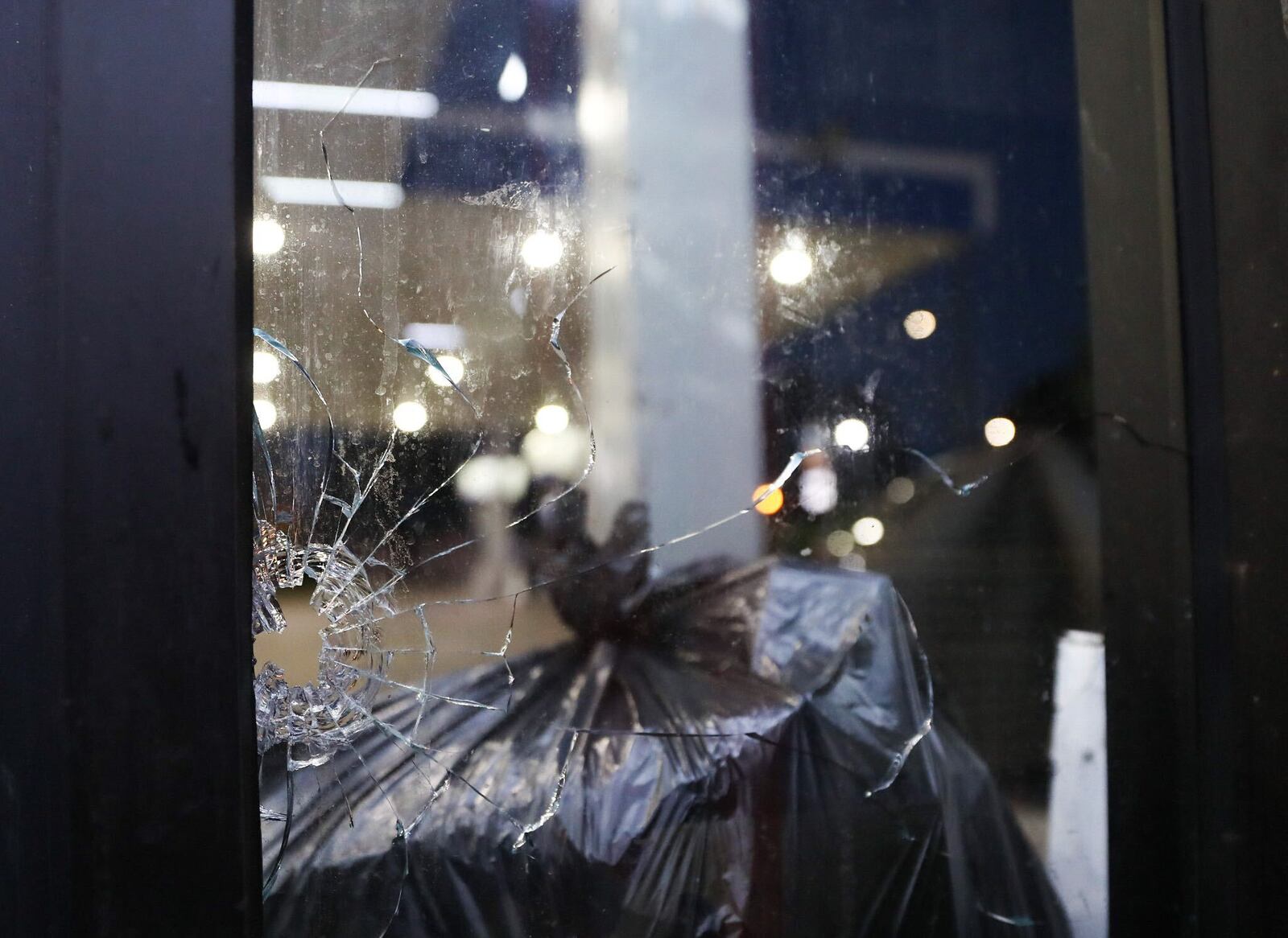 At least one round struck the window of the Candler Road Chevron station when bullets started flying Wednesday morning in the parking lot. 