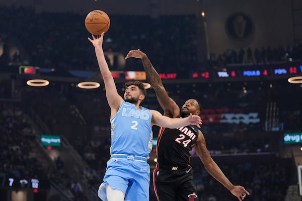 Cleveland Cavaliers guard Ty Jerome (2) shoots in front of Miami Heat forward Haywood Highsmith (24) in the first half of an NBA basketball game Wednesday, March 5, 2025, in Cleveland. (AP Photo/Sue Ogrocki)