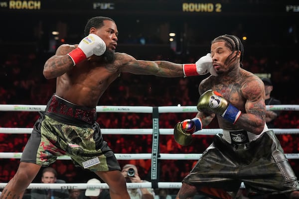 Lamont Roach, left, punches Gervonta Davis during the second round of a WBA lightweight championship boxing bout Saturday, March 1, 2025, in New York. (AP Photo/Frank Franklin II)