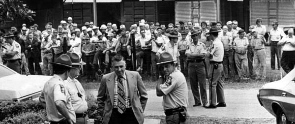 Friends and neighbors of the Aldays wait outside the Seminole courthouse in May 1973 to see the just-captured suspects brought to court. An appeals panel later ruled defendants did not get a fair trial, setting stage for retrials. (Al Stephenson/AJC staff)