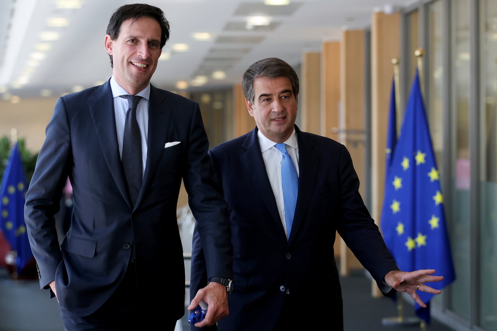 FILE - Designated European Commissioners Wopke Hoekstra, left, and Raffaele Fitto, right, are seen during a first meeting with European Commission President Ursula Von der Leyen in Brussels, Belgium, Sept. 18, 2024. (Olivier Hoslet/Pool Photo via AP, File)