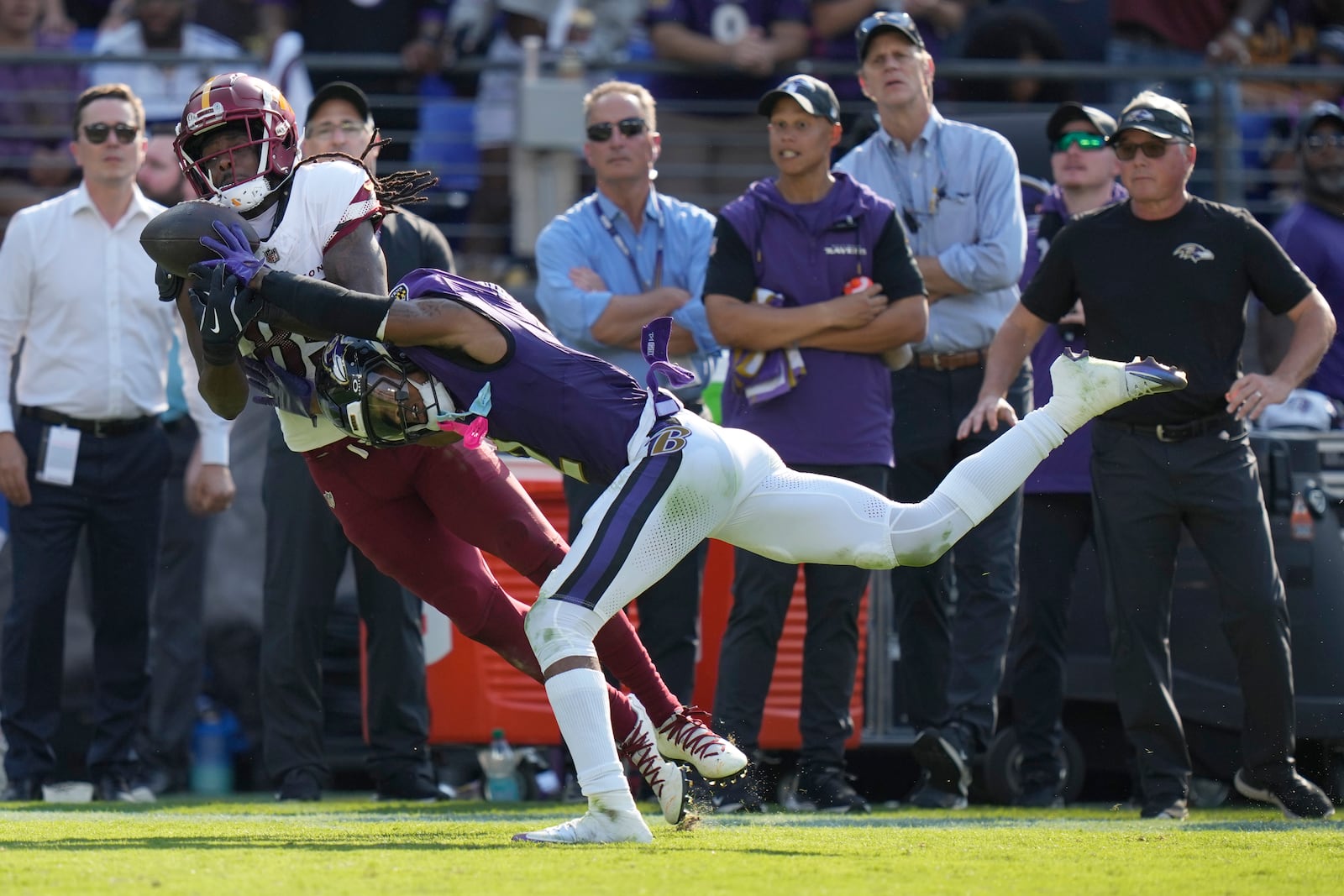 Washington Commanders wide receiver Noah Brown is unable to catch a pass as Baltimore Ravens cornerback Nate Wiggins, right, commits pass interference during the second half of an NFL football game Sunday, Oct. 13, 2024, in Baltimore. (AP Photo/Stephanie Scarbrough)