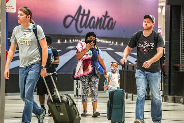 September 1, 2022 Hartsfield-Jackson International Airport: Kenyatta Culver (left-center) and daughter Adriel-4 (right-center) from Florida enter the atrium as they were sandwiched with travelers at Hartsfield-Jackson International domestic Airport on Thursday , Sept. 1, 2022 as Labor Day weekend is expected to bring a rush of traffic on the roads and in the skies as the last holiday of this year’s busy and tumultuous summer travel season. Hartsfield-Jackson International Airport expects to handle 1.6 million passengers over the Labor Day travel period from Thursday through Tuesday, Sept. 6. The Atlanta airport said Friday is likely to be the busiest day of the travel period, with more than 300,000 passengers expected. Airport officials advise travelers to be in the airport terminal at least two hours before departure. The airport’s forecast indicates bigger crowds for Labor Day than last year, when travel was stymied by the spread of the delta variant of COVID-19 and the holiday period drew about 1.3 million passengers. Other busier holiday weekends have brought larger crowds this summer, including Memorial Day and the Fourth of July. Atlanta-based Delta Air Lines and other carriers have struggled to keep flights operating on time when weather disruptions threw schedules into disarray, causing flight cancellations and travel disruptions during some of the busiest periods. Delta said it has worked this summer to restore its operational reliability. The hassles of air travel have prompted some to decide to drive instead of fly, according to one survey. About 32% of those surveyed by AAA said they plan to travel for Labor Day weekend, and of those, 82% plan to drive. (John Spink / John.Spink@ajc.com)

