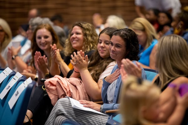 Educators clap for Kim Sarfaty, a special education pre-K teacher at Chestatee Elementary School, at orientation for new Forsyth County teachers at Denmark High School in Alpharetta, Georgia, on Tuesday, July 27, 2021. (Rebecca Wright for the Atlanta Journal-Constitution)