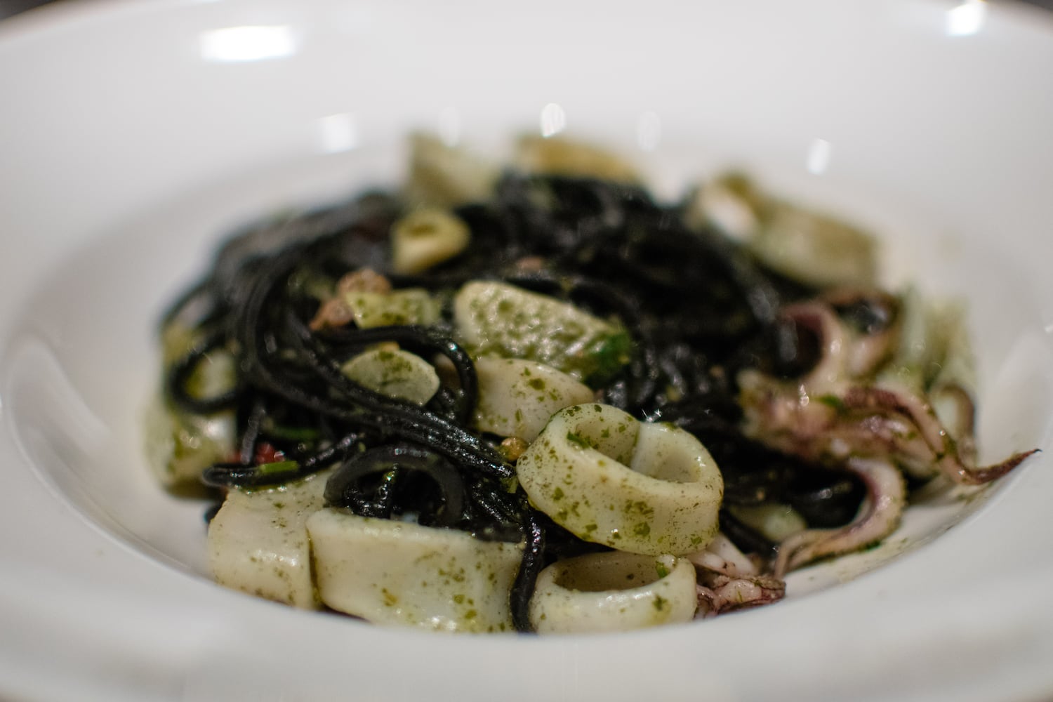 Squid ink spaghetti with calamari, Calabrian chiles and Thai basil pesto at La Tavola Trattoria. CONTRIBUTED BY HENRI HOLLIS