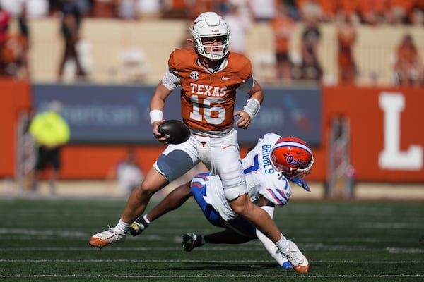 Texas quarterback Arch Manning (16) scrambles past Florida defensive back Trikweze Bridges (7) during the second half of an NCAA college football game in Austin, Texas, Saturday, Nov. 9, 2024. (AP Photo/Eric Gay)