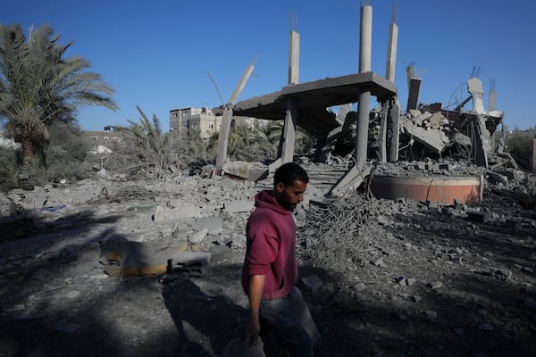 A Palestinian walks past a destroyed building following an overnight Israeli strike in Deir al-Balah, Gaza Strip, Wednesday, Dec. 4, 2024. (AP Photo/Abdel Kareem Hana)