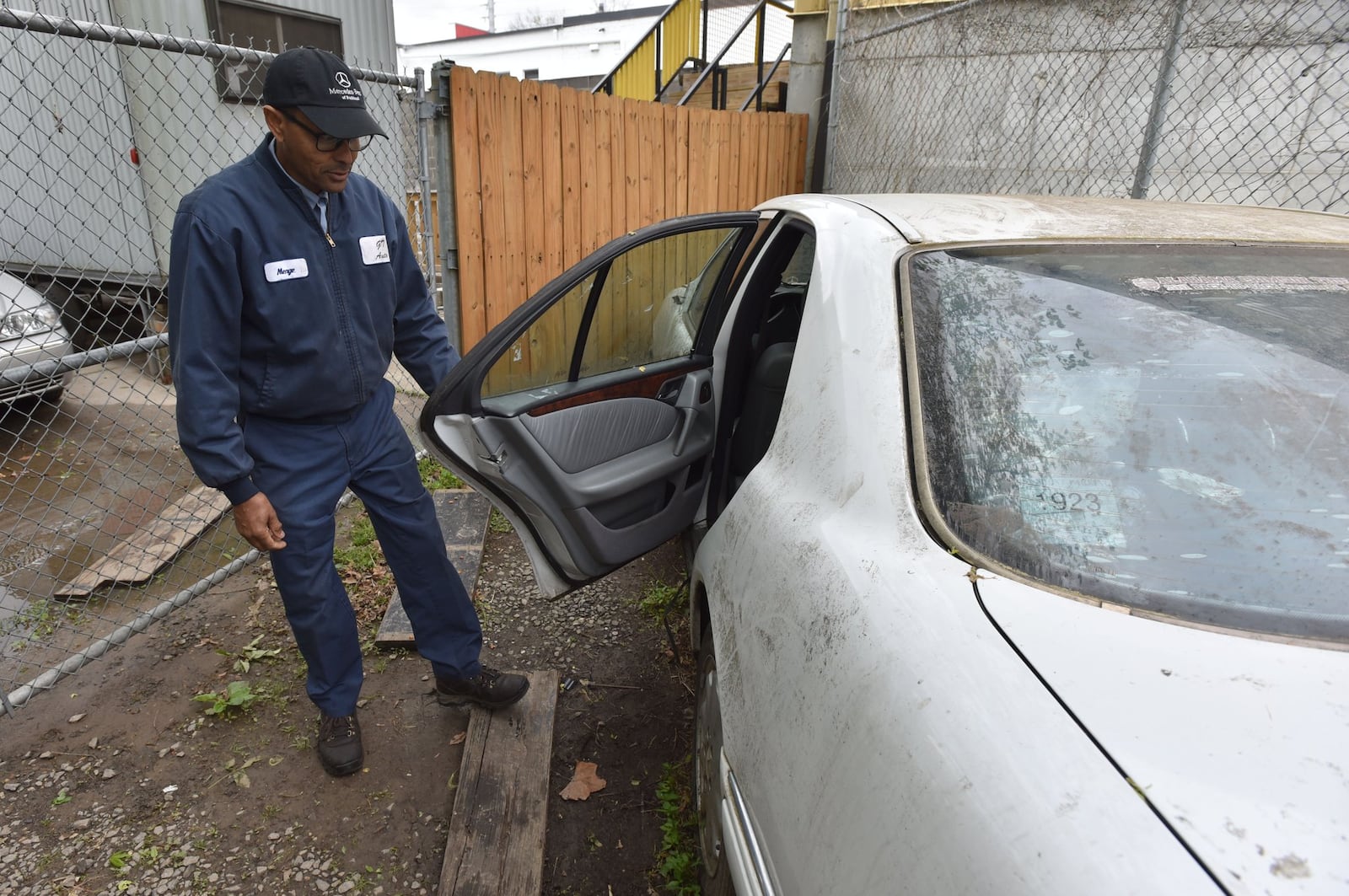 April 6, 2017 Atlanta - Menge Gizachew, owner of GT Auto Repair, shows a broken-down Mercedes where he let Basil Eleby sleep. Eleby is the homeless man charged with starting the fire that brought down I-85. HYOSUB SHIN / HSHIN@AJC.COM